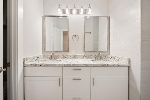 bathroom featuring a sink and double vanity