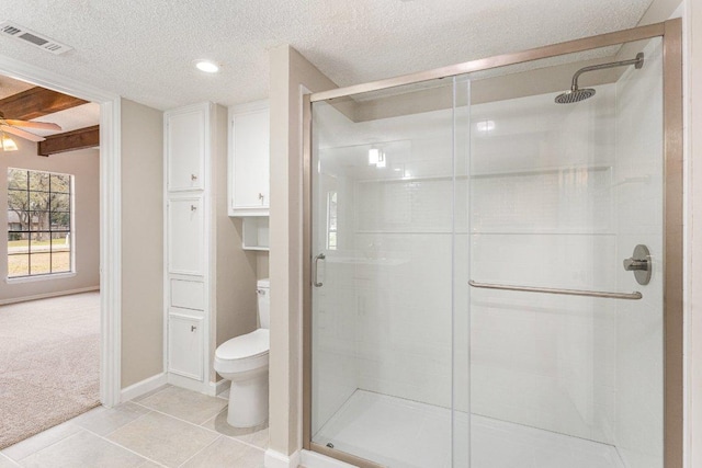 full bath with visible vents, toilet, tile patterned floors, a textured ceiling, and a shower stall