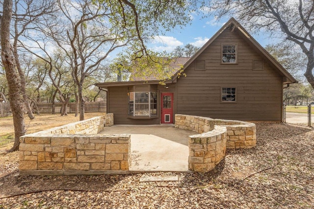 rear view of property with fence and a patio