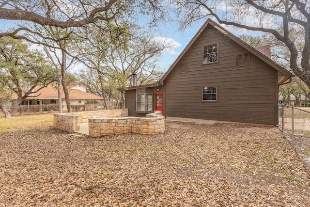 back of property featuring a patio area and fence