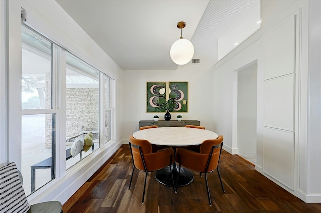 dining room featuring dark wood-style floors, visible vents, and baseboards