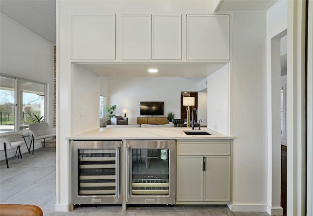 bar featuring wine cooler, a sink, and light tile patterned flooring