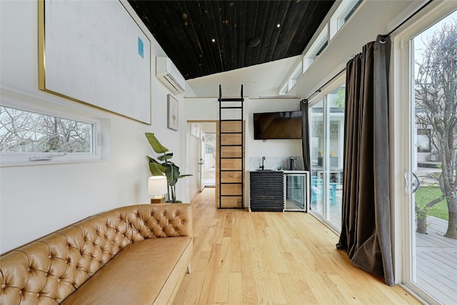 kitchen featuring lofted ceiling, hardwood / wood-style floors, a wall unit AC, and wood ceiling