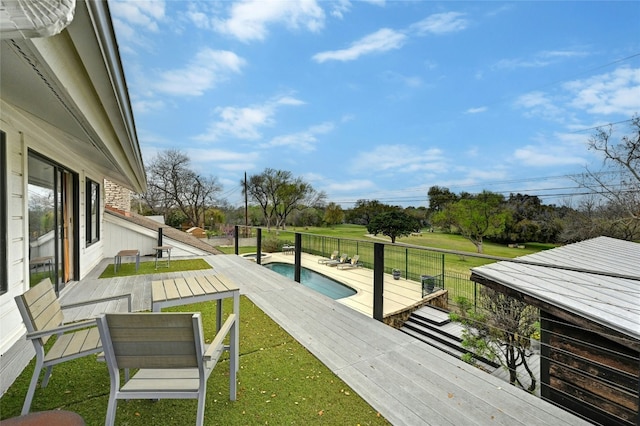 exterior space with a wooden deck and a fenced in pool