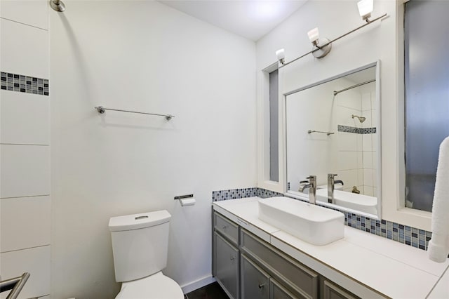 full bath with a shower, vanity, and toilet