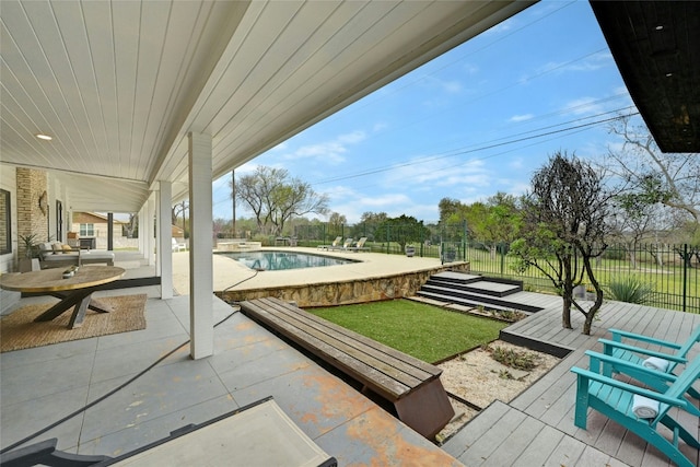 view of patio / terrace with a fenced in pool and fence