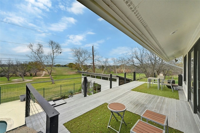 wooden terrace featuring a yard and fence