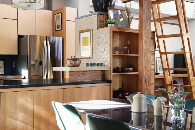 kitchen featuring stainless steel refrigerator with ice dispenser