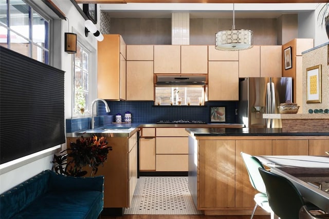 2010 S 2nd St, Austin, TX 78704 - kitchen with stainless steel fridge, backsplash, hanging light fixtures, under cabinet range hood, and cooktop
