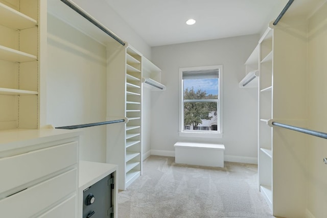 walk in closet featuring light carpet