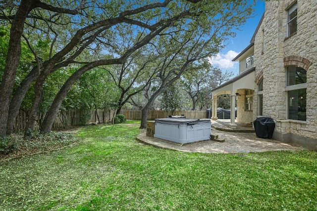 view of yard with a hot tub, a patio area, and a fenced backyard