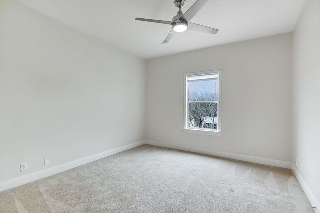 unfurnished room featuring carpet, a ceiling fan, and baseboards