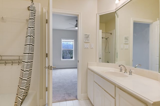 bathroom with baseboards, shower / bath combination with curtain, vanity, and a ceiling fan