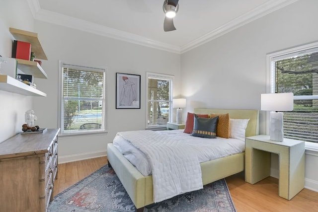 bedroom featuring baseboards, ceiling fan, ornamental molding, and light wood-style floors