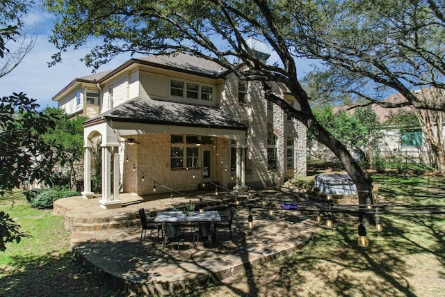 rear view of property featuring a patio and stucco siding