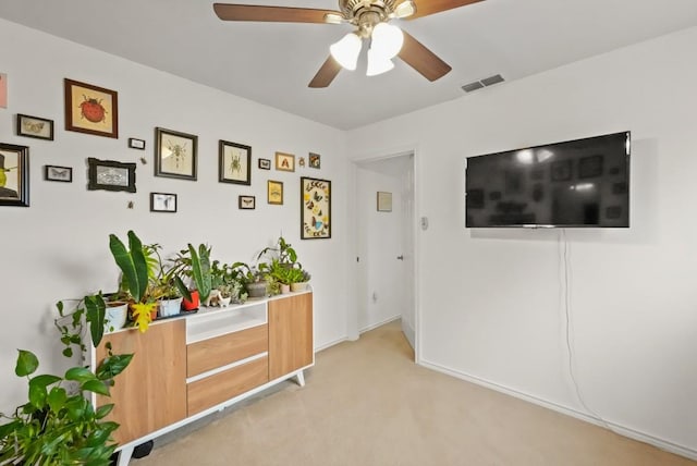 interior space with ceiling fan and visible vents