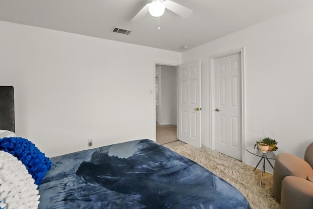 carpeted bedroom with visible vents and a ceiling fan