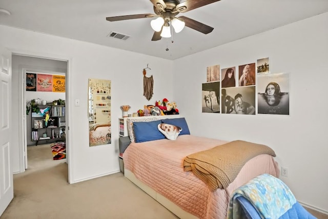 carpeted bedroom with visible vents and ceiling fan