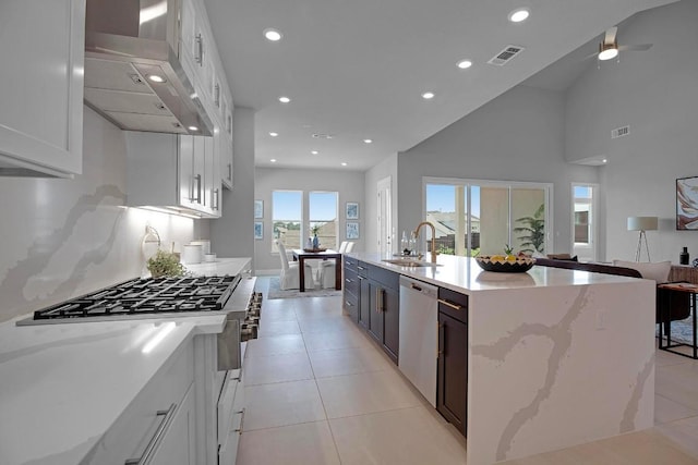 16909 Roselin Dr, Austin, TX 78738 - kitchen featuring stainless steel appliances, wall chimney exhaust hood, open floor plan, a sink, and recessed lighting