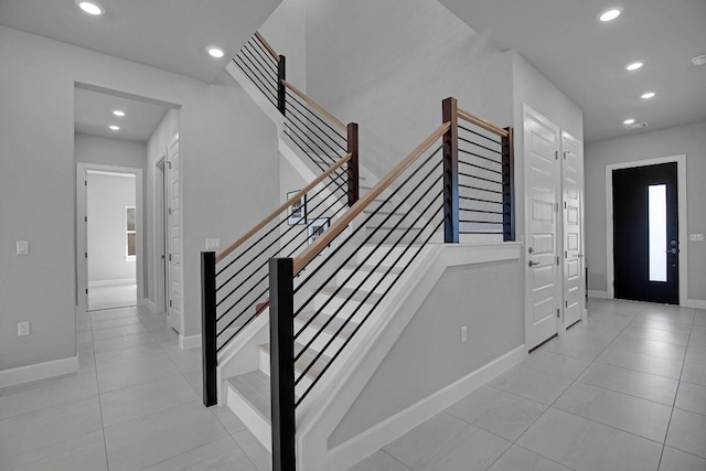 stairs featuring recessed lighting, baseboards, and tile patterned floors