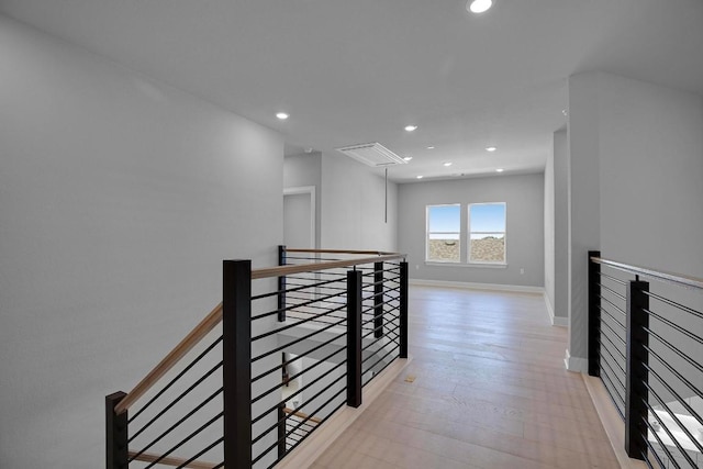 hall with attic access, recessed lighting, an upstairs landing, and light wood-type flooring