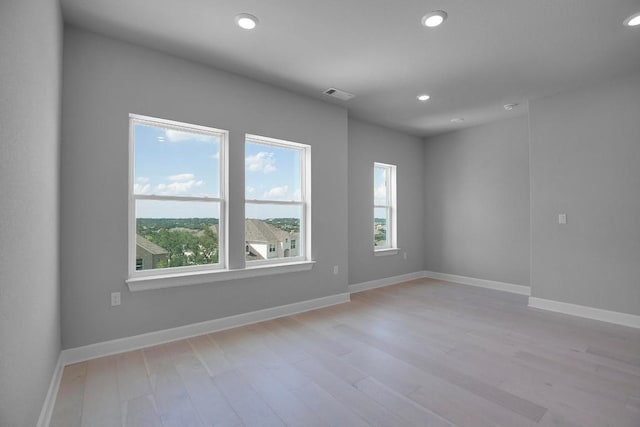 16909 Roselin Dr, Austin, TX 78738 - empty room featuring healthy amount of natural light, recessed lighting, baseboards, and light wood-style floors