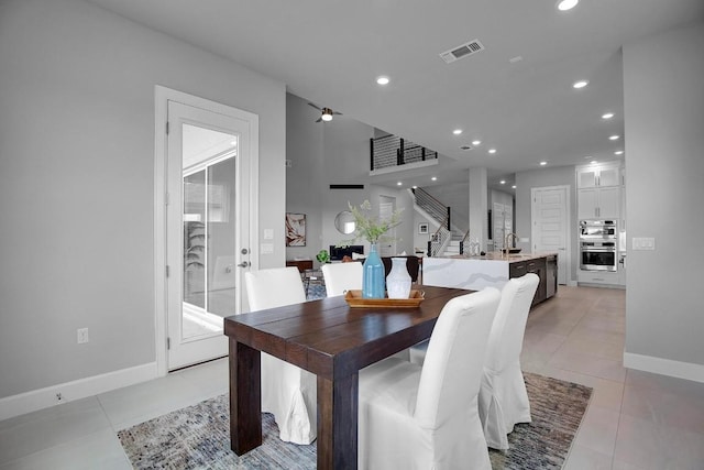 dining room with light tile patterned floors, visible vents, stairs, and recessed lighting