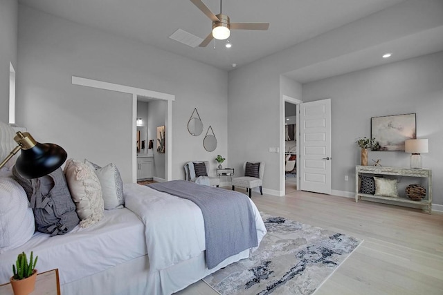 bedroom with wood finished floors, baseboards, recessed lighting, ceiling fan, and ensuite bathroom