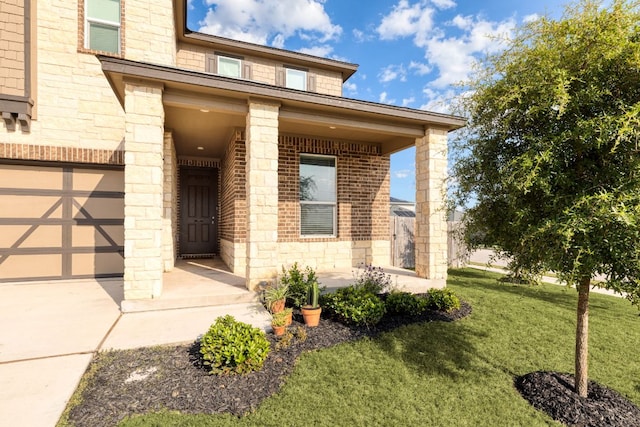 property entrance with a yard, brick siding, and stone siding