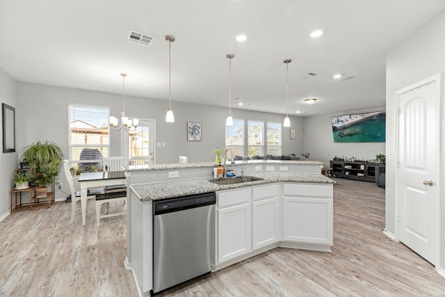 kitchen with a sink, light wood finished floors, white cabinets, and dishwasher