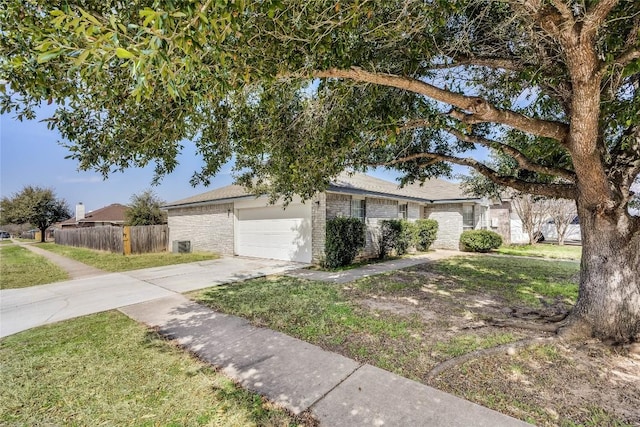 single story home with driveway, a garage, fence, a front lawn, and brick siding