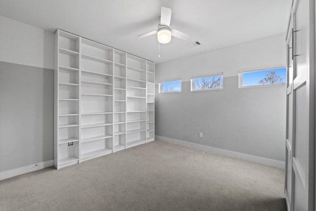 unfurnished bedroom featuring a ceiling fan, light colored carpet, visible vents, and baseboards