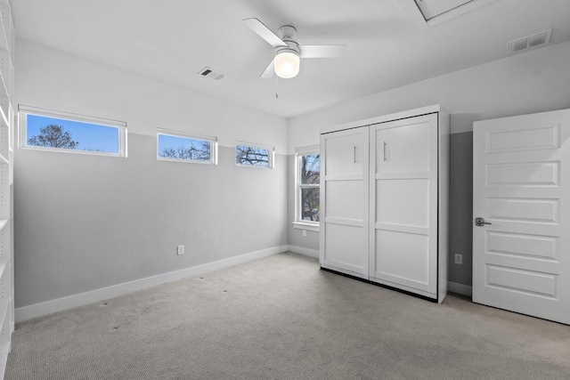 unfurnished bedroom featuring baseboards, visible vents, ceiling fan, and carpet flooring