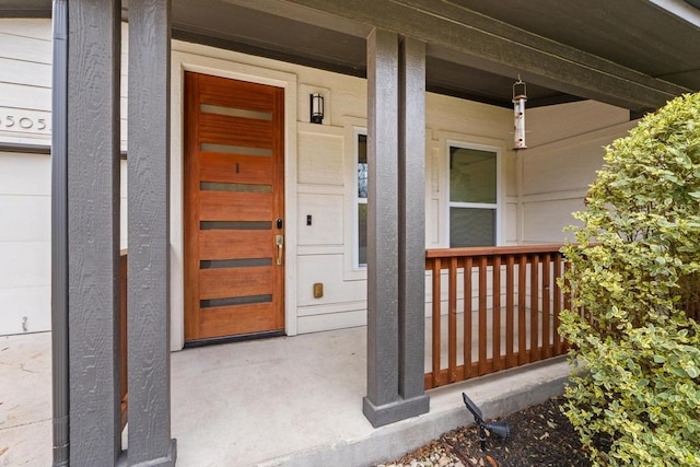 view of exterior entry featuring a porch