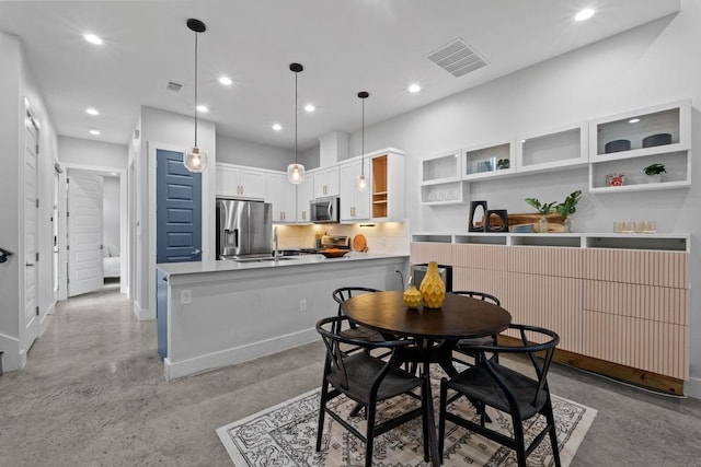 dining area with recessed lighting, visible vents, concrete floors, and baseboards