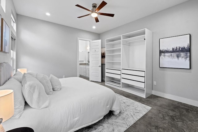 bedroom with recessed lighting, ensuite bathroom, ceiling fan, concrete flooring, and baseboards