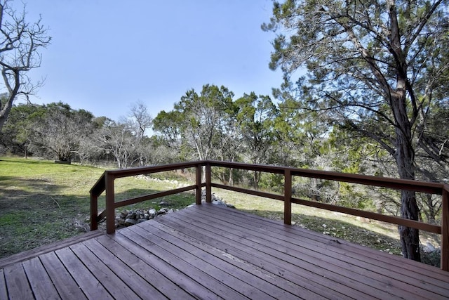 wooden terrace featuring a yard