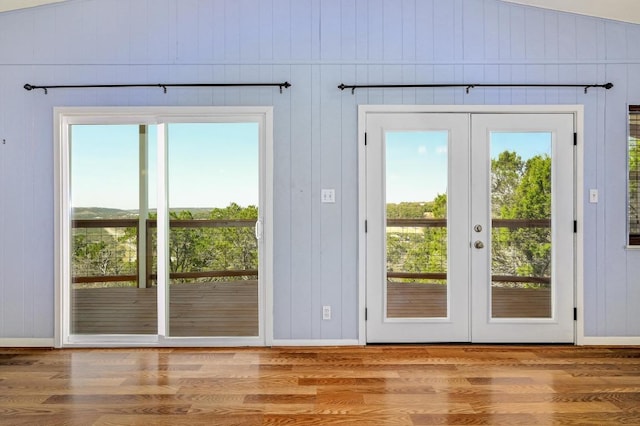 doorway to outside with plenty of natural light, wood finished floors, and french doors