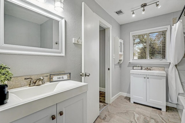 full bathroom featuring visible vents, vanity, and track lighting