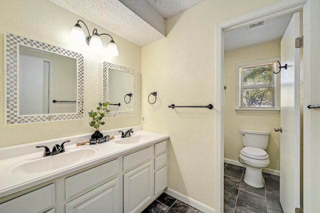 full bathroom with double vanity, visible vents, toilet, and a sink