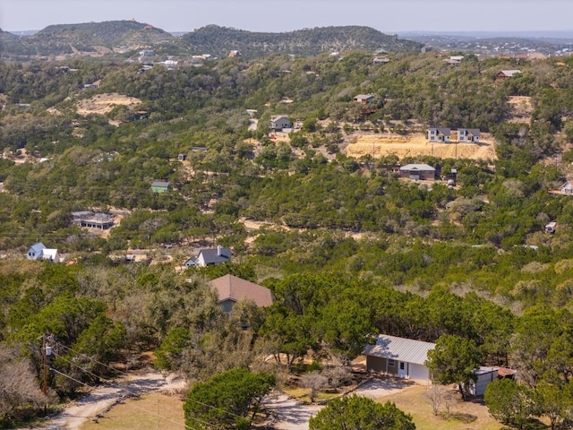 birds eye view of property with a forest view and a mountain view