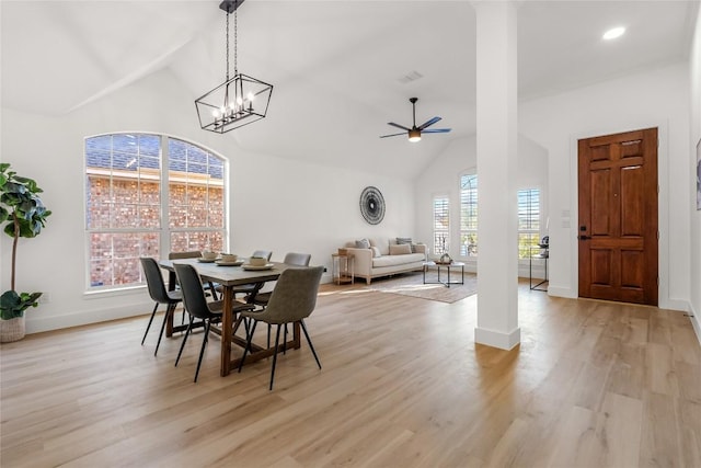 dining space featuring visible vents, high vaulted ceiling, a ceiling fan, and light wood-style floors