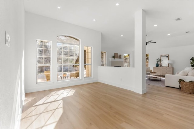 unfurnished living room with light wood-type flooring, a ceiling fan, and recessed lighting