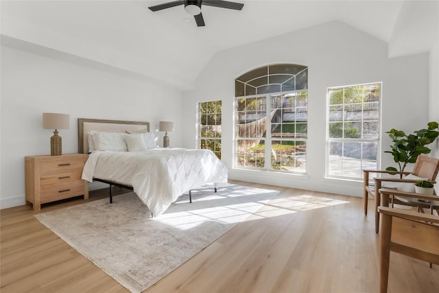 bedroom featuring lofted ceiling, light wood-style flooring, and ceiling fan