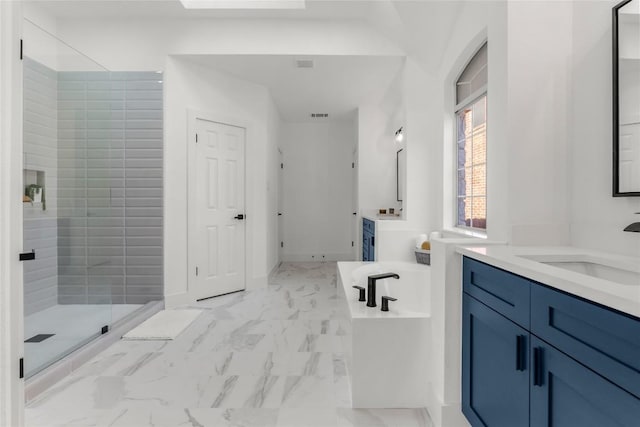 full bathroom with two vanities, a sink, marble finish floor, a soaking tub, and a stall shower