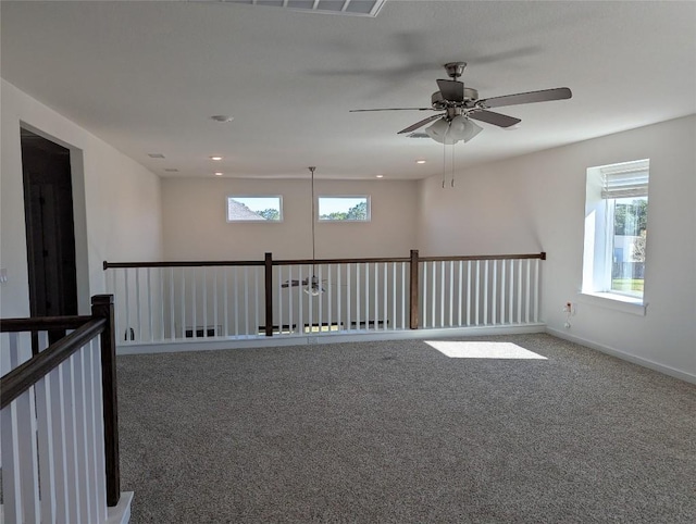 carpeted empty room with baseboards, ceiling fan, recessed lighting, and a healthy amount of sunlight