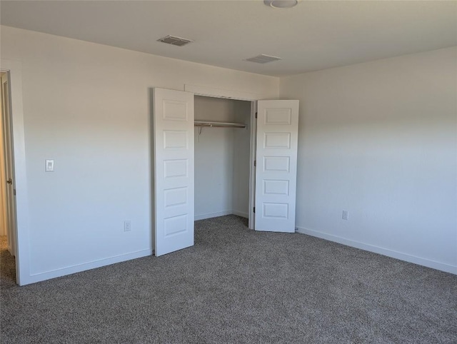 unfurnished bedroom featuring a closet, carpet, visible vents, and baseboards