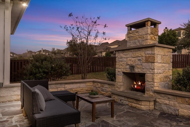 view of patio / terrace featuring a fenced backyard and an outdoor stone fireplace