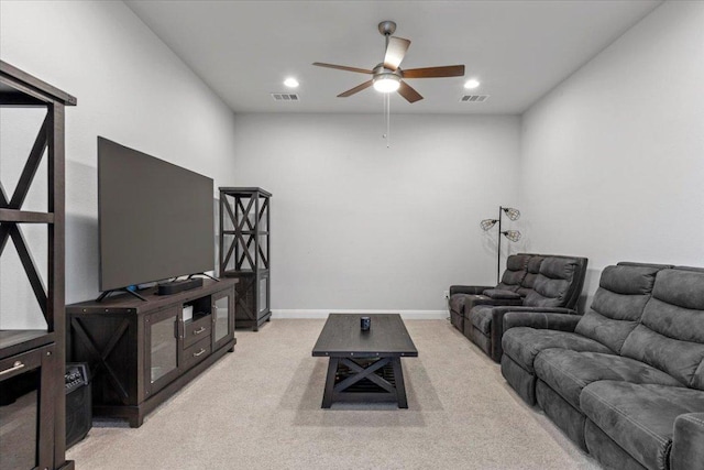 living area with baseboards, visible vents, a ceiling fan, and light colored carpet