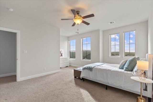 bedroom featuring a ceiling fan, baseboards, visible vents, and carpet flooring